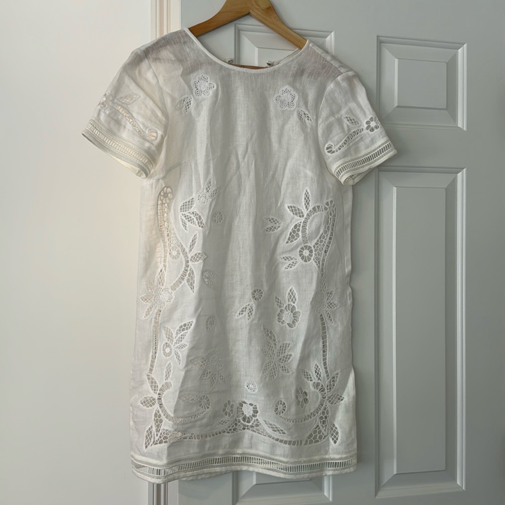 White linen mini dress with floral cut out details